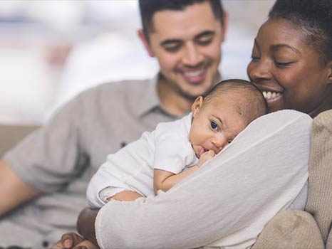 a young couple and their infant