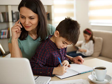 a young mother works from home alongside her children