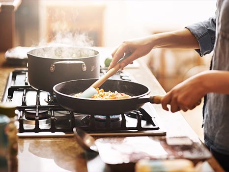 Hands preparing food in a domestic kitchen